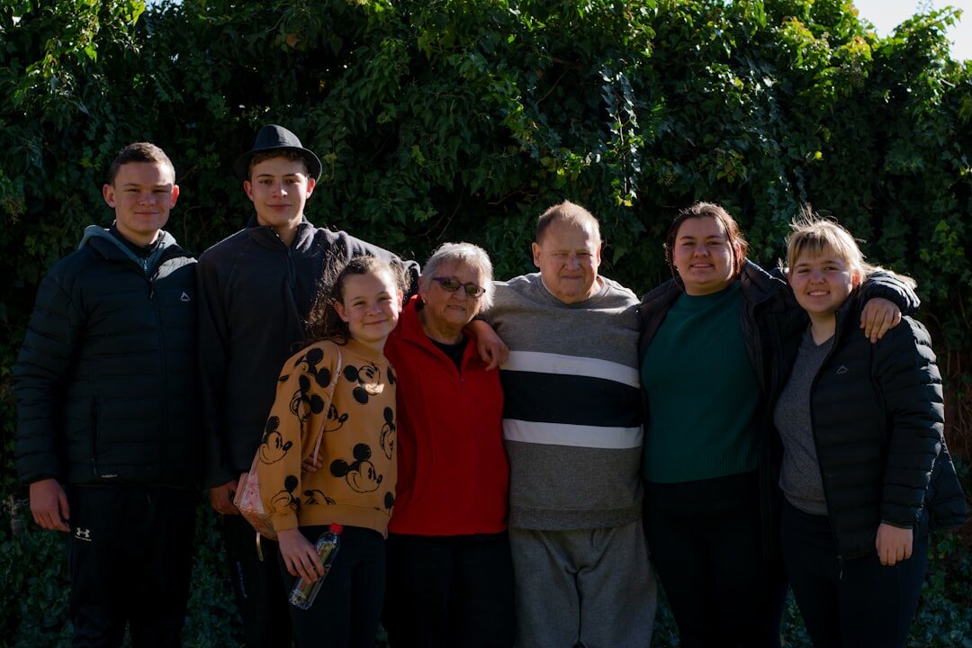 Founding members and staff of a Croatian senior community club posing together indoors