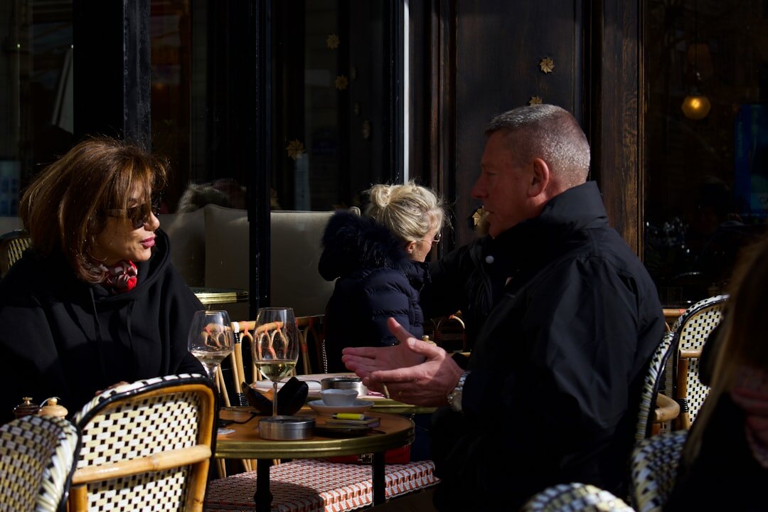 Croatian senior couple enjoying coffee at a partner cafe with a membership card