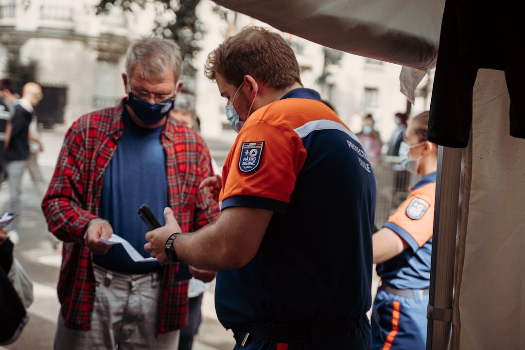 Croatian club coordinator helping a senior member with registration on a tablet
